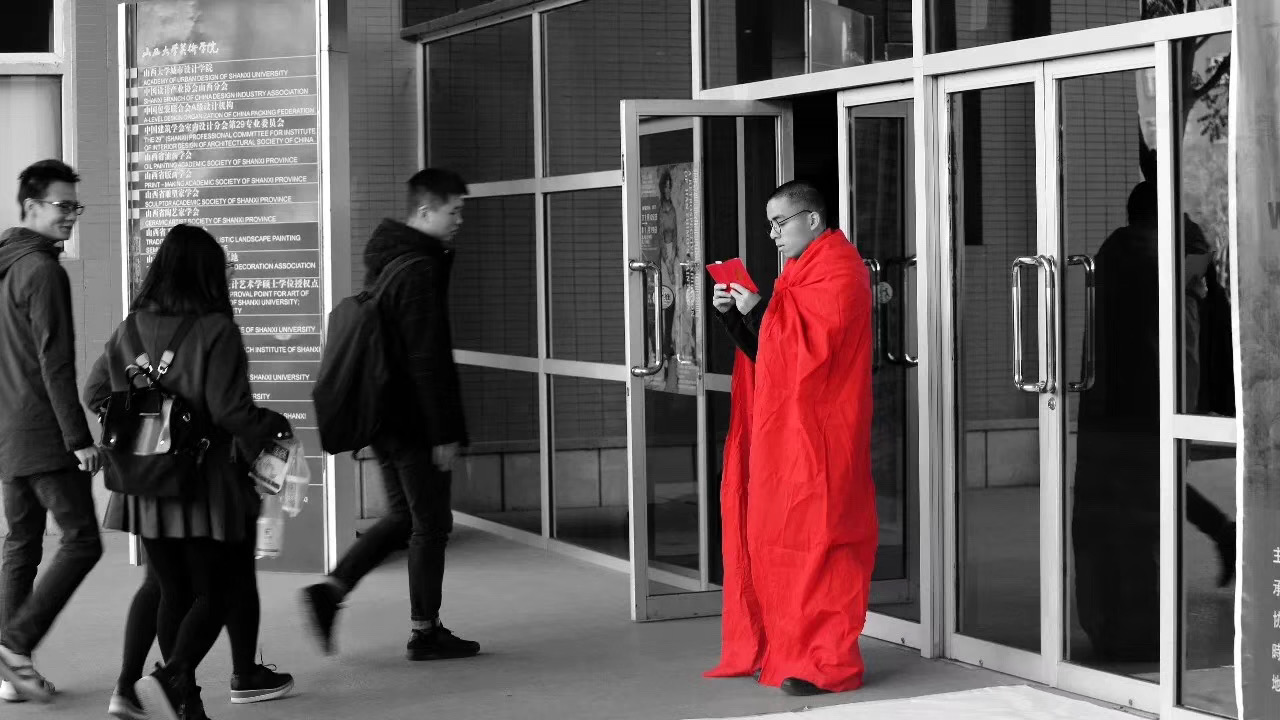Artist pacing with red cloth and book during Late performance